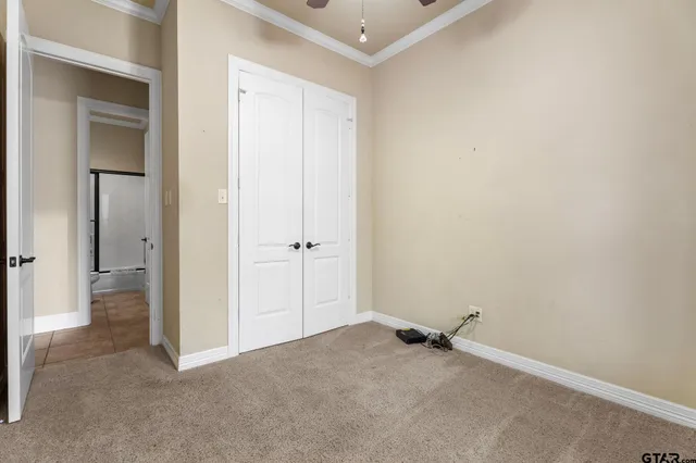 a view of a room with closet and wooden door