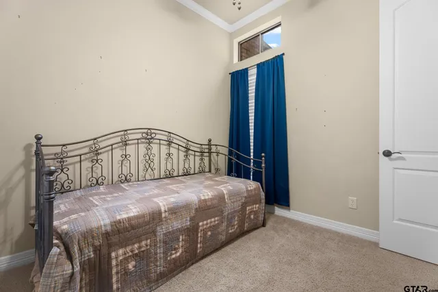 a bedroom with a bed table and a window