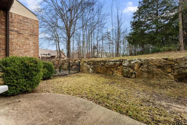 a pathway of a house with a yard
