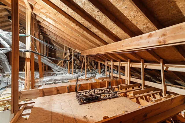 a view of a balcony with chairs and wooden fence