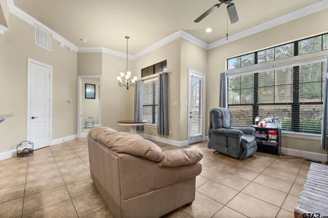 a living room with furniture and a chandelier