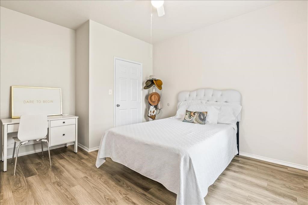 115 Collett Court Weatherford, TX 76088 - Photo 6 of 11 a bedroom with a bed and wooden floor