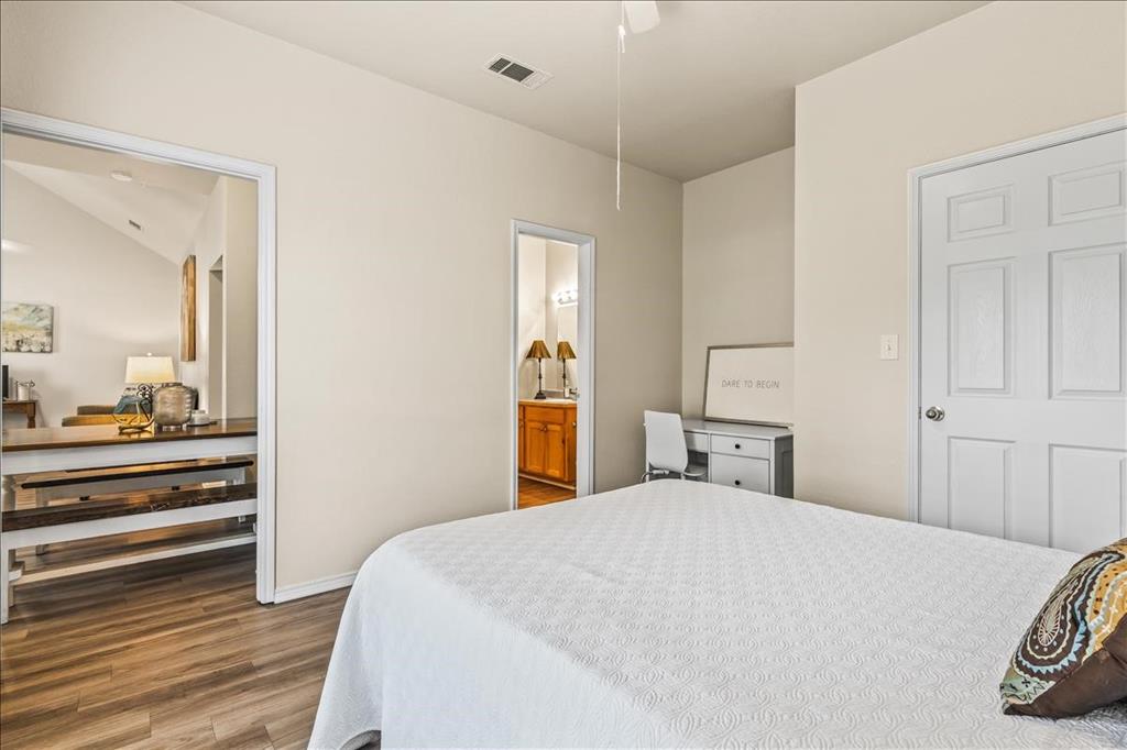 115 Collett Court Weatherford, TX 76088 - Photo 7 of 11 a bedroom with a bed and a dresser