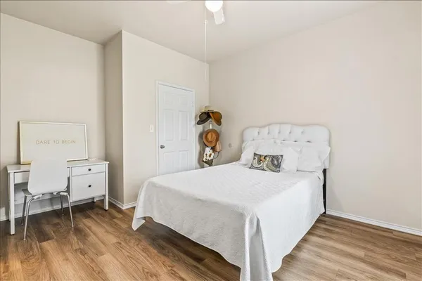 a bedroom with a bed and a table in it