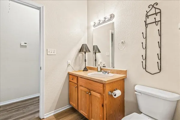 a bathroom with a toilet sink and mirror