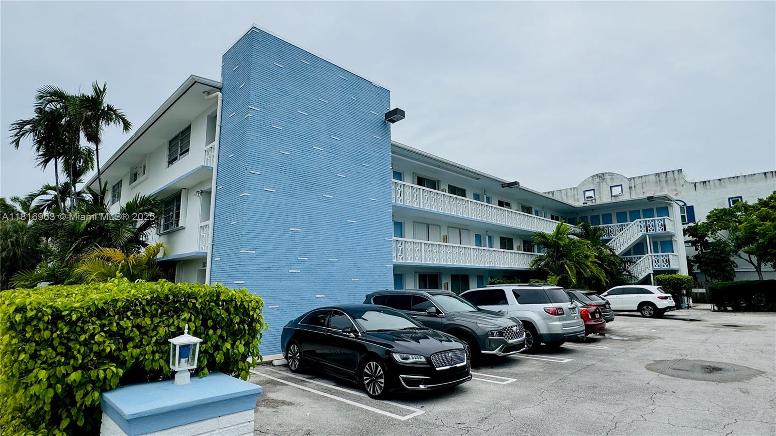 1120 102nd Street, Unit 7 Bay Harbor Islands, FL 33154 - Photo 1 of 22 a car parked in front of a brick house with large windows