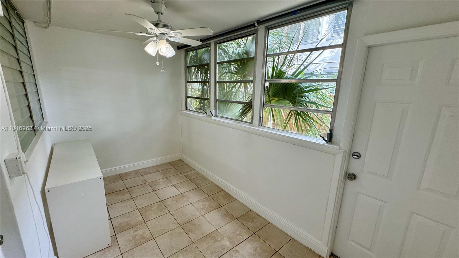 1120 102nd Street, Unit 7 Bay Harbor Islands, FL 33154 - Photo 19 of 22 an empty room with windows and outdoor view