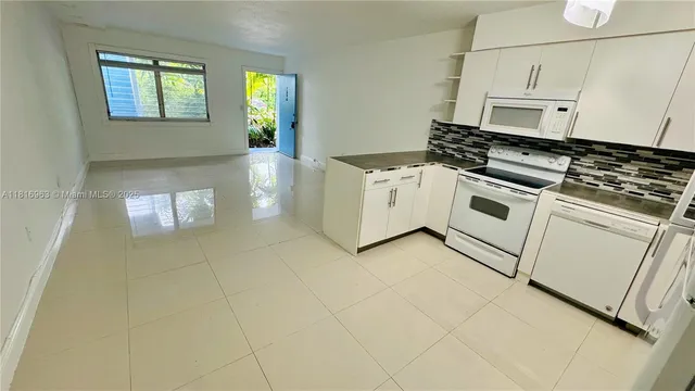 a kitchen with cabinets and appliances