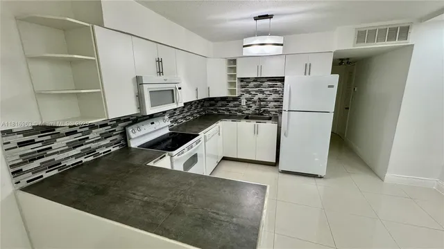 a kitchen with a sink a stove and refrigerator