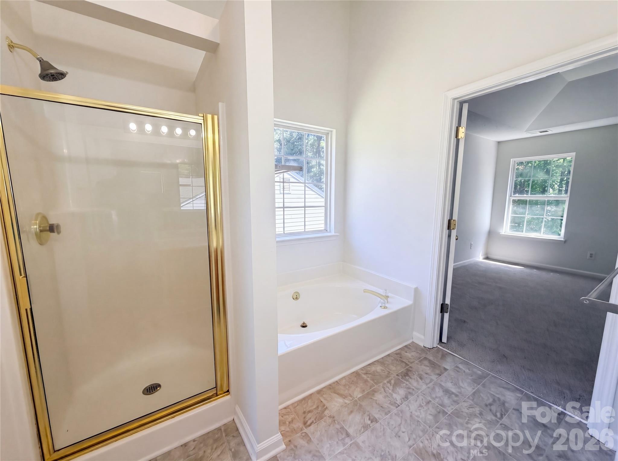 7423 Henderson Park Road Huntersville, NC 28078 - Photo 13 of 16 a bathroom with a bathtub and a shower