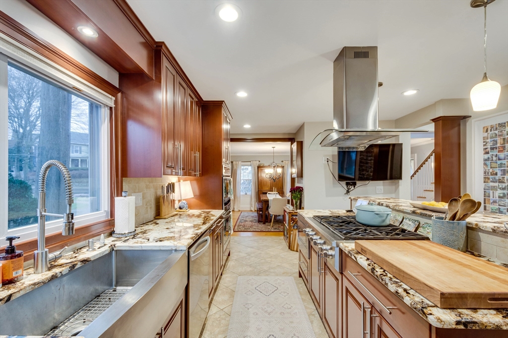 12 Mishawum Road Woburn, MA 01801 - Photo 17 of 39 a large kitchen with kitchen island granite countertop a large counter top space a sink stainless steel appliances and cabinets
