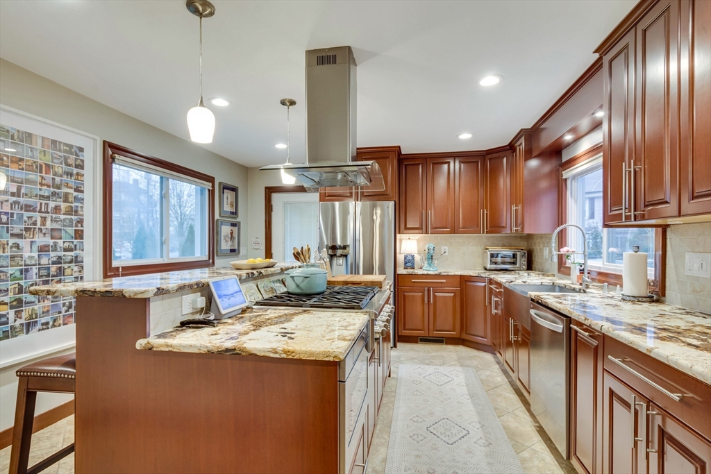 12 Mishawum Road Woburn, MA 01801 - Photo 18 of 39 a kitchen with granite countertop kitchen island stainless steel appliances a sink stove and cabinets
