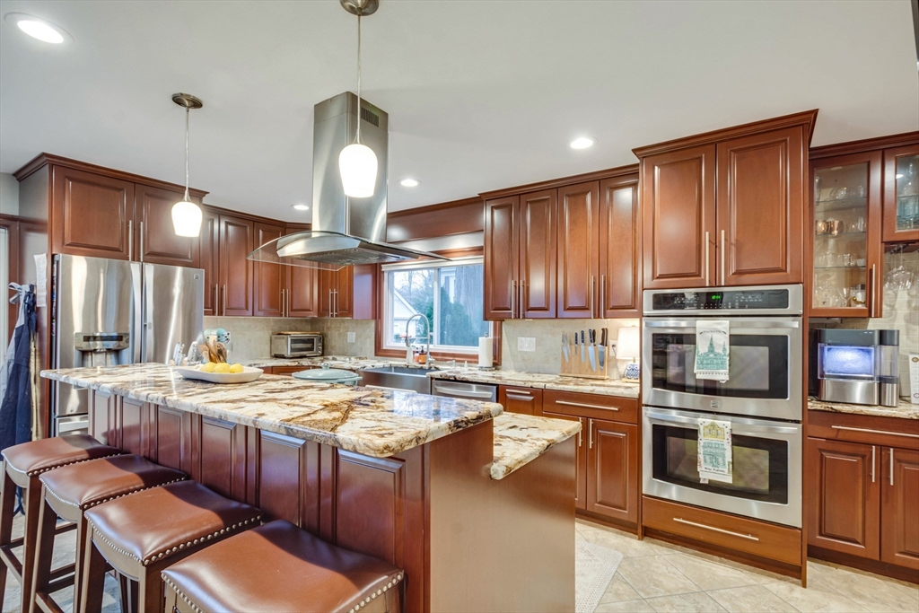12 Mishawum Road Woburn, MA 01801 - Photo 19 of 39 a kitchen with stainless steel appliances granite countertop a stove a sink and a refrigerator