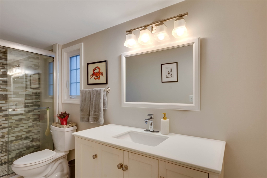 12 Mishawum Road Woburn, MA 01801 - Photo 20 of 39 a bathroom with a sink mirror vanity and toilet