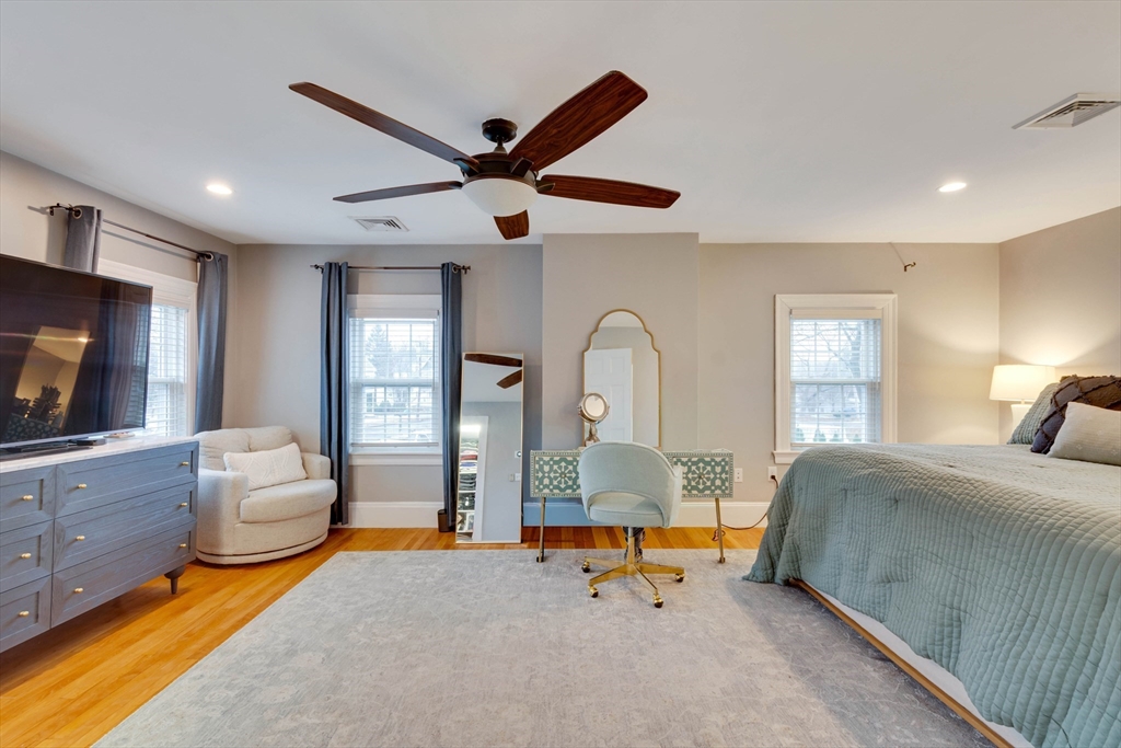 12 Mishawum Road Woburn, MA 01801 - Photo 24 of 39 a bedroom with furniture and a flat screen tv