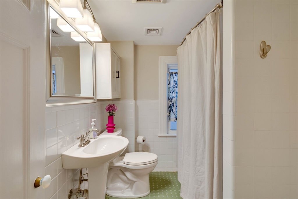 12 Mishawum Road Woburn, MA 01801 - Photo 26 of 39 a bathroom with a sink toilet and a mirror