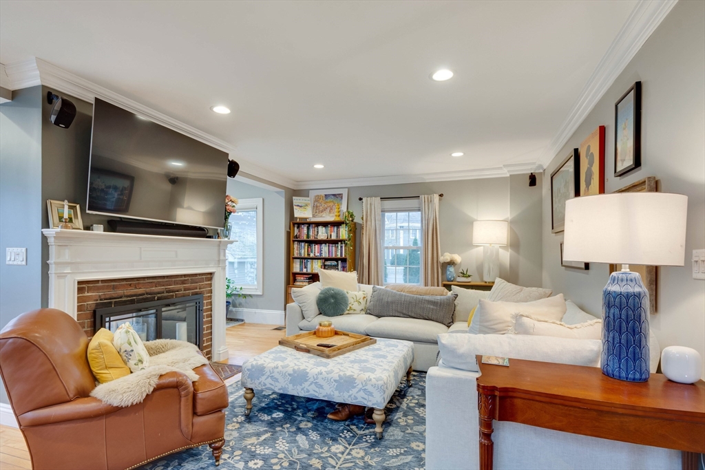 12 Mishawum Road Woburn, MA 01801 - Photo 8 of 39 a living room with furniture a fireplace and a flat screen tv