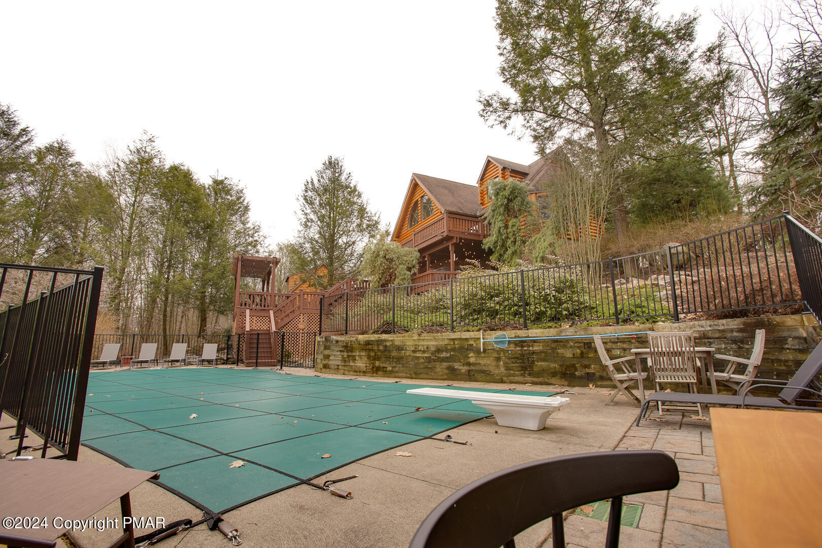 85 Starview Lane Wapwallopen, PA 18660 - Photo 46 of 102 a view of a patio with couches table and chairs under an umbrella with wooden fence