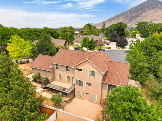 1279 West 1500th Street North Mapleton, UT 84664 - Photo 65 of 83 Multi-story residence featuring stucco and horizontal siding, a brown shingle roof, and a prominent second-story deck with metal railing
