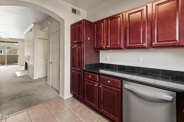 a kitchen with stainless steel appliances granite countertop a refrigerator and cabinets