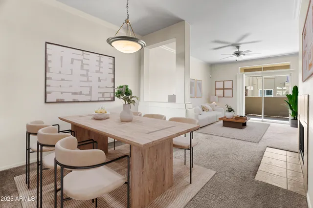 a view of a dining room with furniture and a chandelier