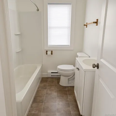 a bathroom with a sink a toilet and bathtub