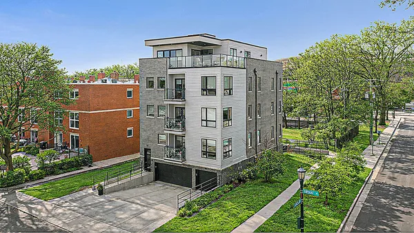 a view of a large building with a yard