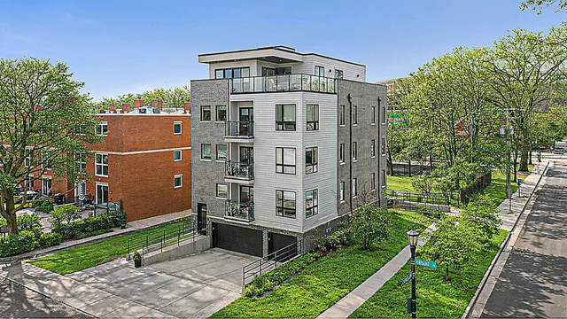 a view of a large building with a yard