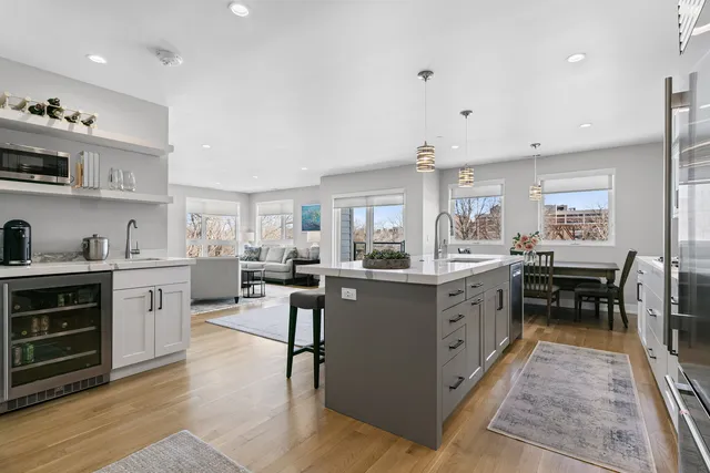a kitchen with sink stove and cabinets