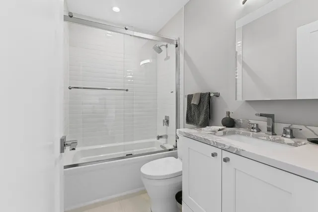 a bathroom with a granite countertop toilet sink and shower