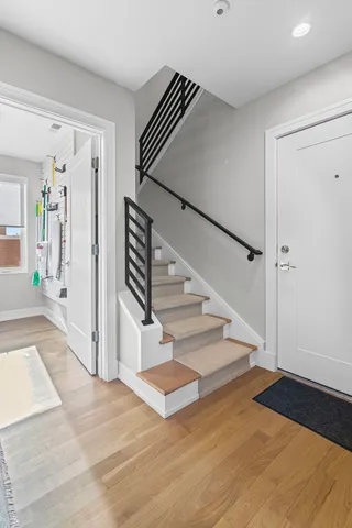 a view of entryway and hall with wooden floor