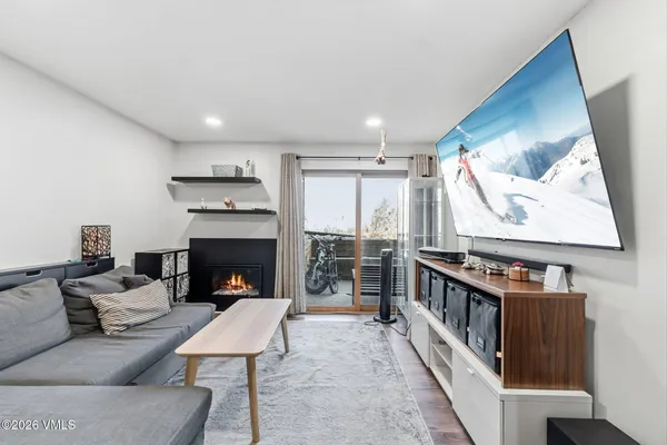 a living room with furniture a fireplace and a flat screen tv
