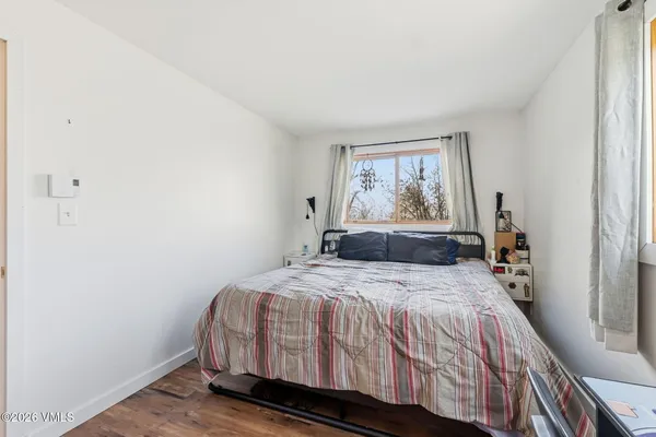 a bedroom with a bed and window