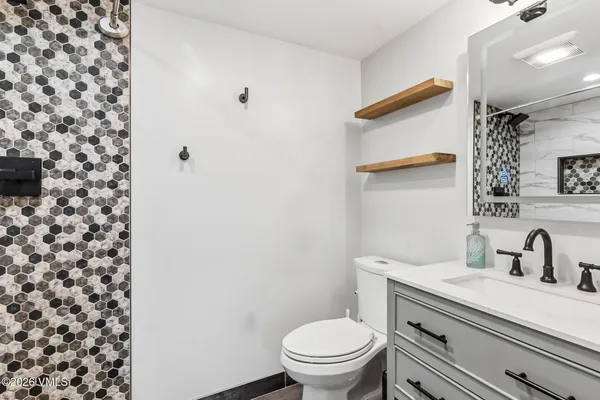a bathroom with a sink toilet and shower