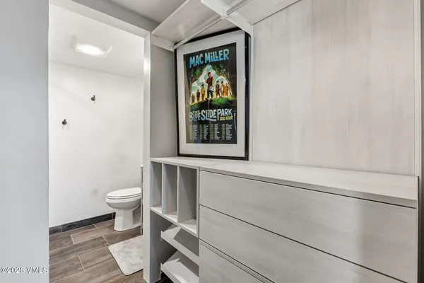 a bathroom with a toilet and a window