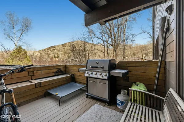 a view of a roof deck with couches and wooden floor
