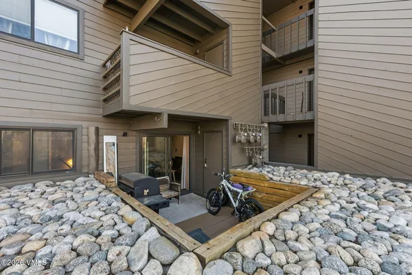 a backyard of a house with barbeque oven table and chairs