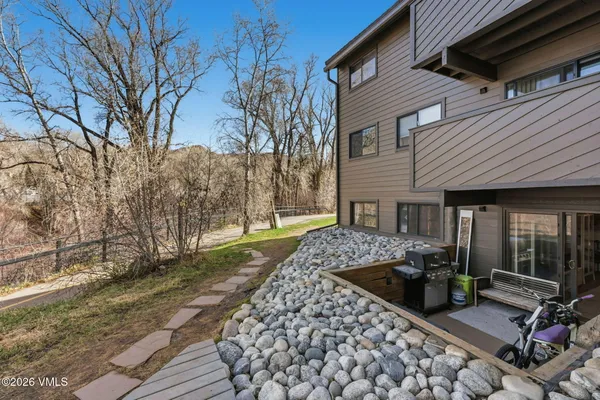 a wooden bench sitting in front of a house