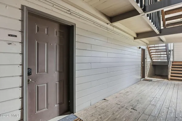 a view of a house with a door and wooden floor