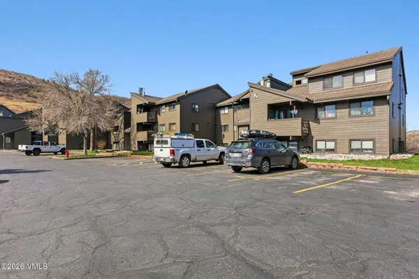a view of a street that has couple of cars parked on the road