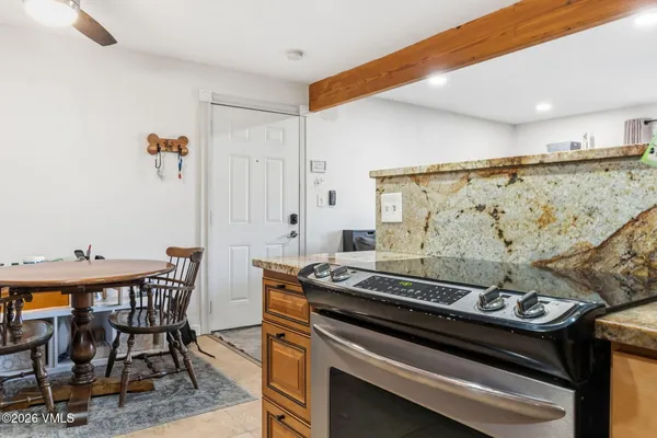 a kitchen with a stove and a table