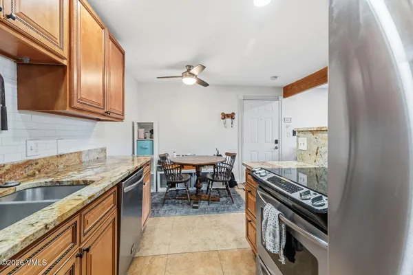 a kitchen with a stove sink and cabinets