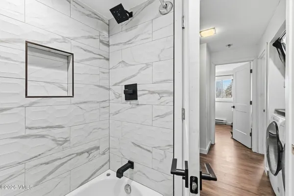 a bathroom with a bathtub and a shower