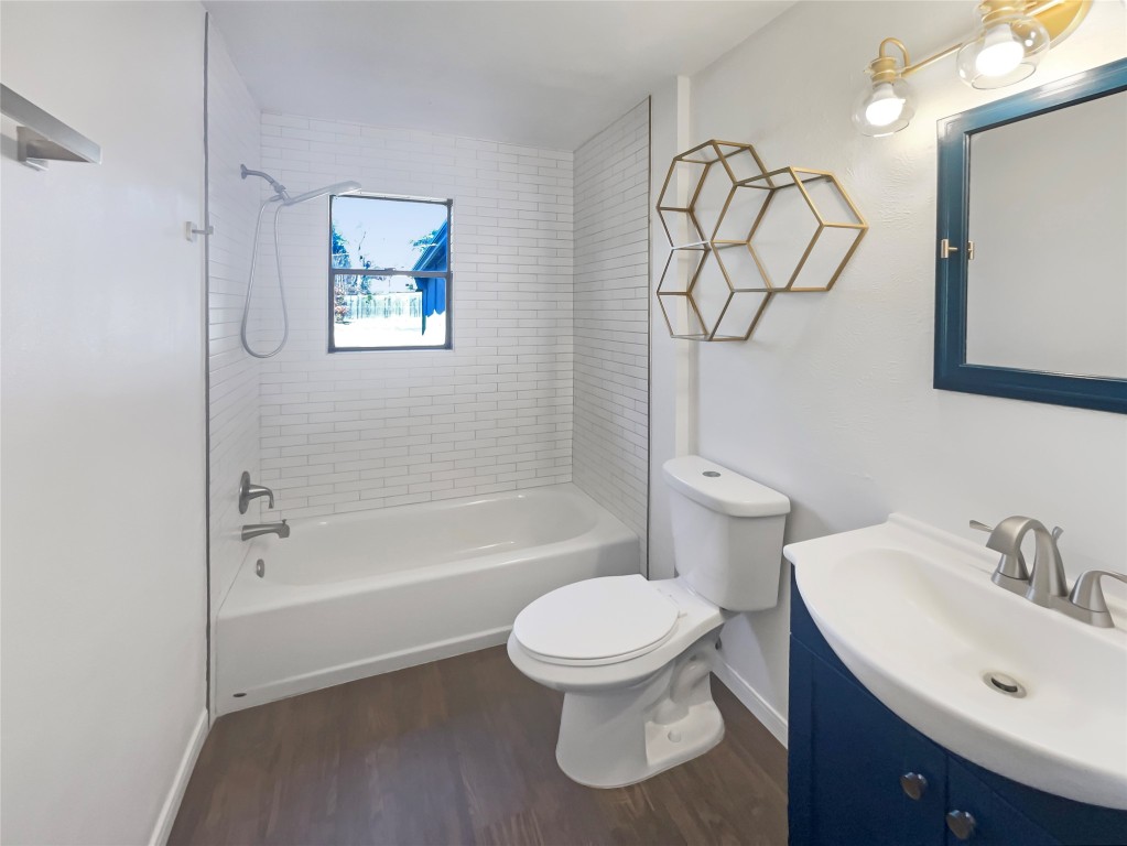 1105 East 17th Street Georgetown, TX 78626 - Photo 12 of 17 a bathroom with a toilet sink and bathtub