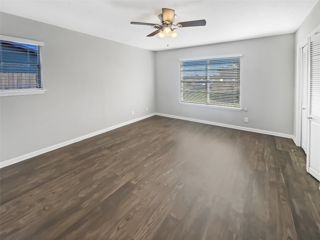 1105 East 17th Street Georgetown, TX 78626 - Photo 14 of 17 an empty room with wooden floor ceiling fan and windows