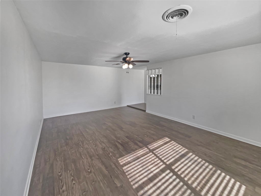 1105 East 17th Street Georgetown, TX 78626 - Photo 3 of 17 an empty room with wooden floor and windows