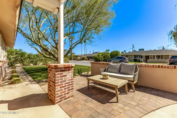 a backyard of a house with outdoor seating