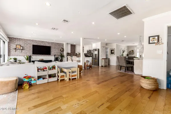 a living room with lots of furniture and view of kitchen