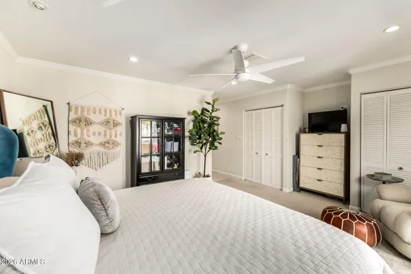 a bedroom with a large bed and a window