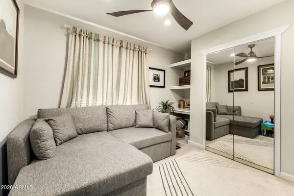 a living room with furniture and a large window